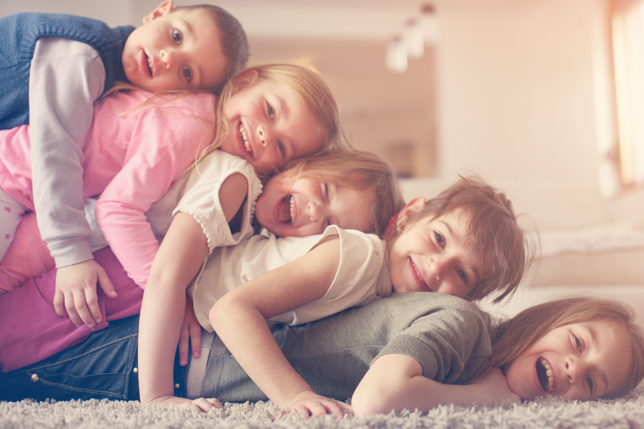 Three siblings having a silly time.