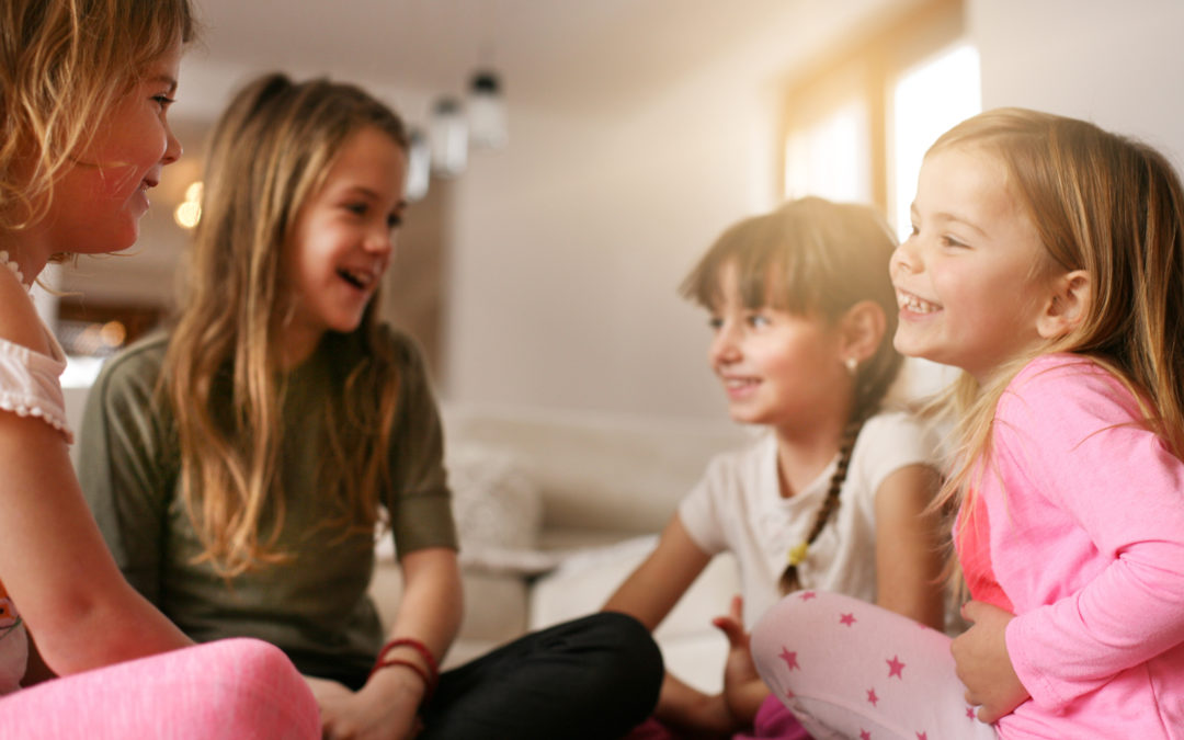 Girls sitting on the floor and talking about something fun.