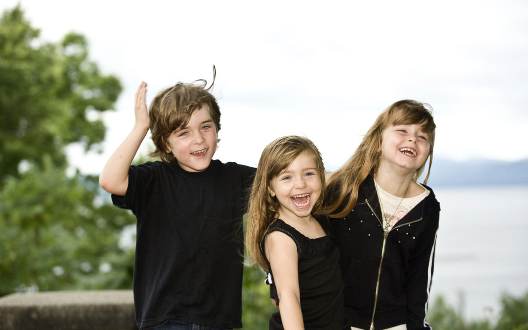 Three siblings having a silly time.