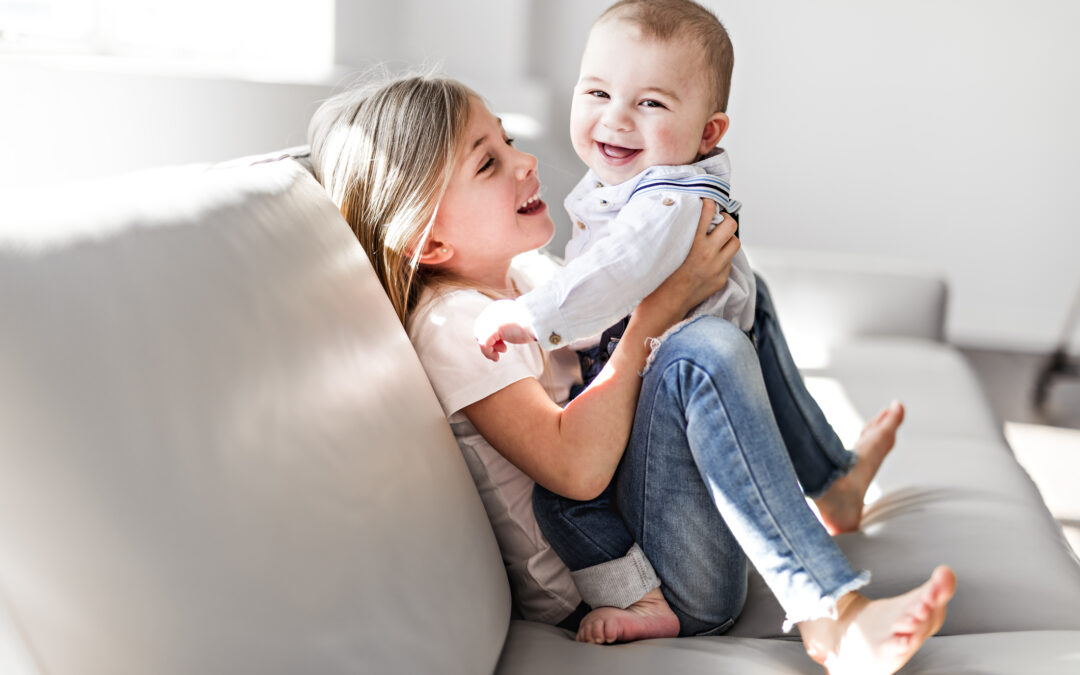 Little sister with her baby brother. Toddler kid Family with children at home.