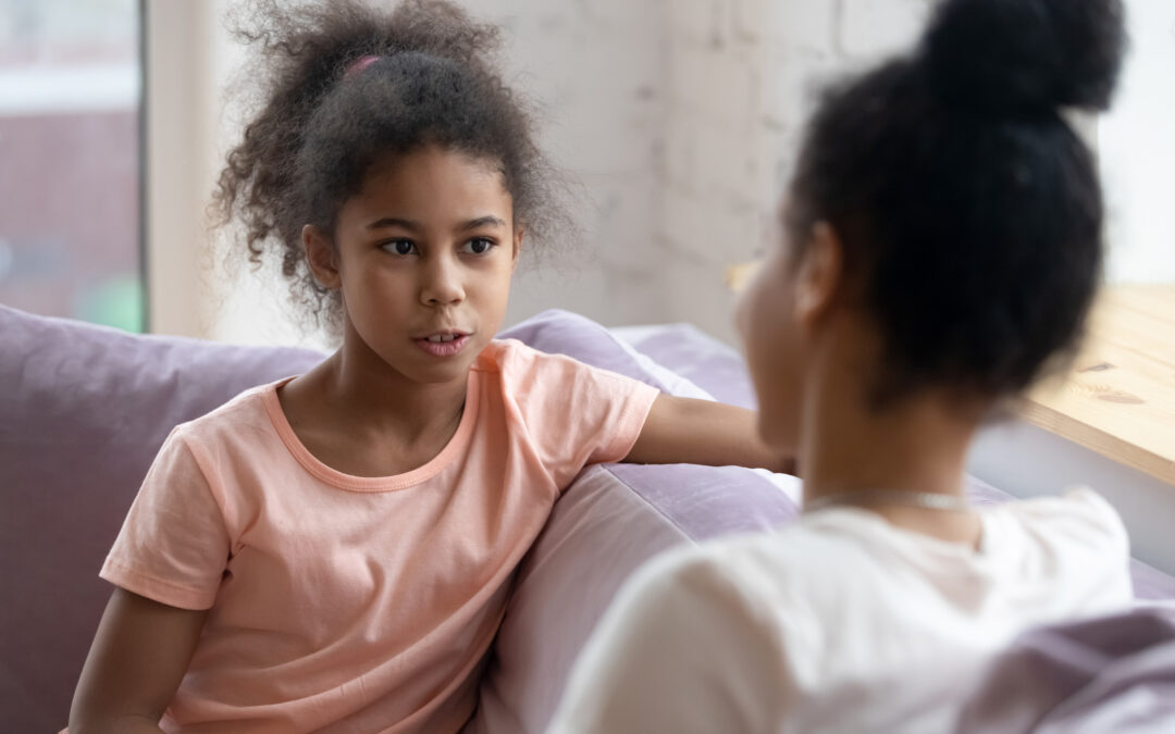 Preteen girl talking and sharing secrets with understanding mother