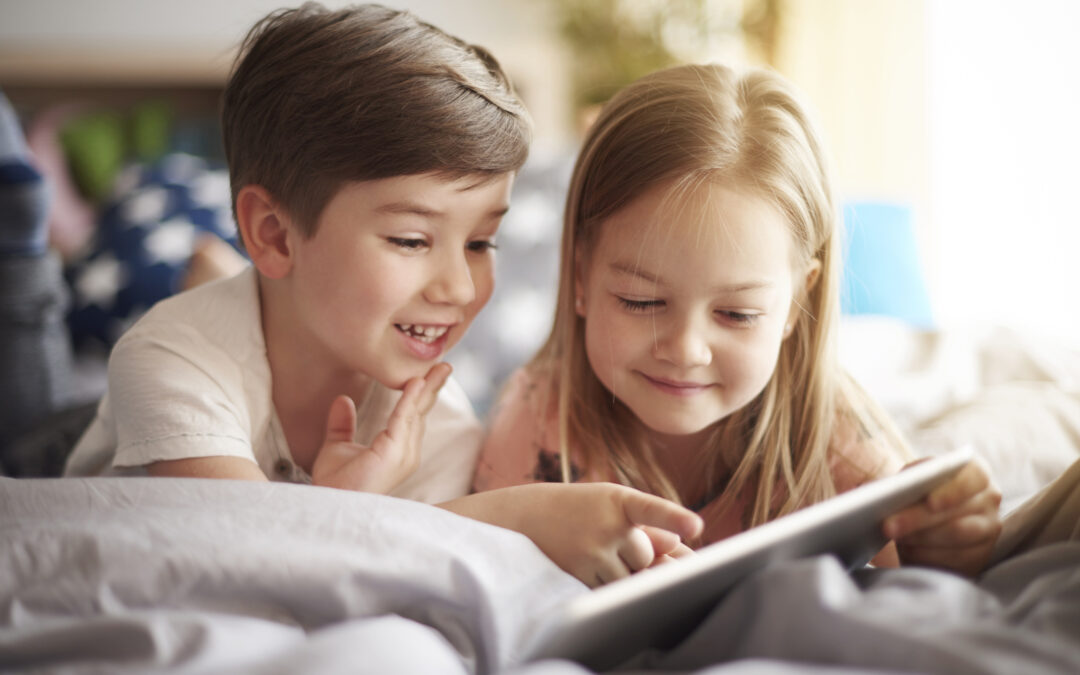 Siblings browsing a digital tablet